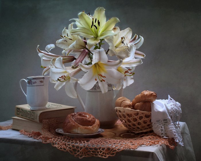 Still-life with lilies, pastries, and books