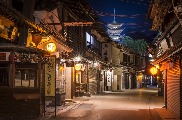 Night street in Miyajima, Japan with pagoda