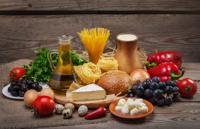 Still-life of Italian ingredients with pasta, cheese, and vegetables