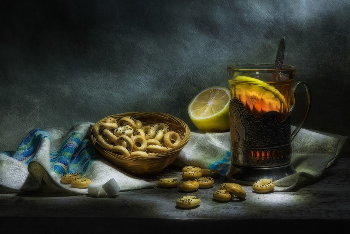 Still life with tea, pastries, and lemon