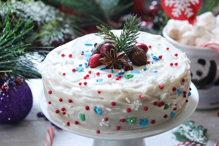 Christmas cake with white frosting and festive decorations
