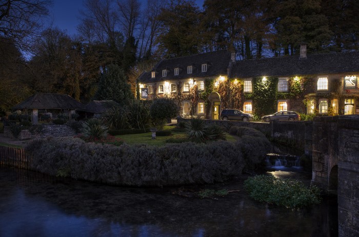 Bibury village houses and river at dusk, England