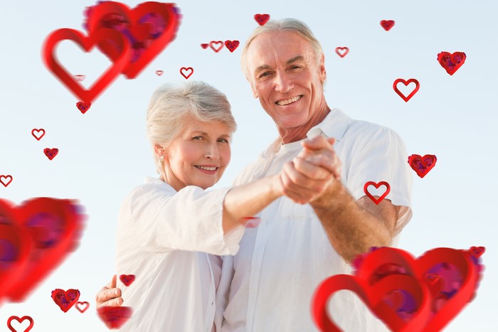 Elderly Couple Dancing with Hearts