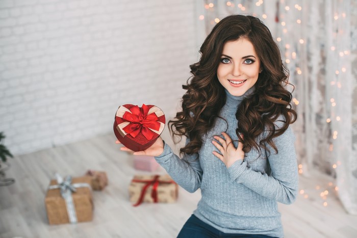 Woman holding a heart-shaped gift box