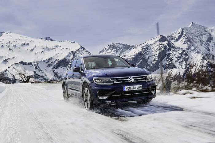 Blue Volkswagen Tiguan R-Line on snowy mountain road
