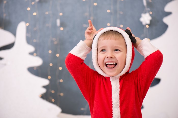 Boy in Santa Costume Laughing