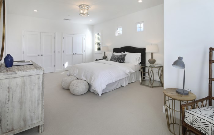 Bedroom with white bedding and dark headboard