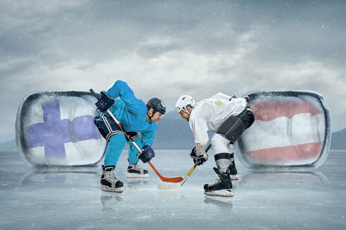 Hockey players from Finland and Austria face off