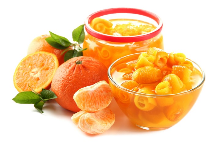 Oranges and orange jam in a jar and bowl