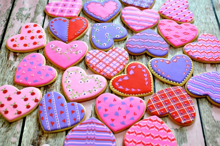 Heart-shaped cookies with various designs on wood