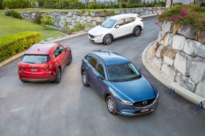 Three Mazda CX-5 Cars on a Road