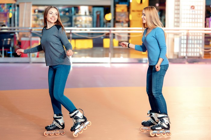 Two women roller skating
