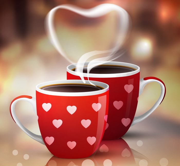 Two coffee cups with hearts and steam