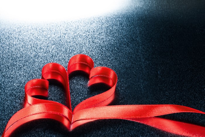 Red Ribbon Heart on Textured Surface