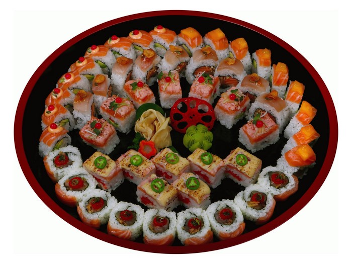 Assortment of sushi and rolls on a black platter