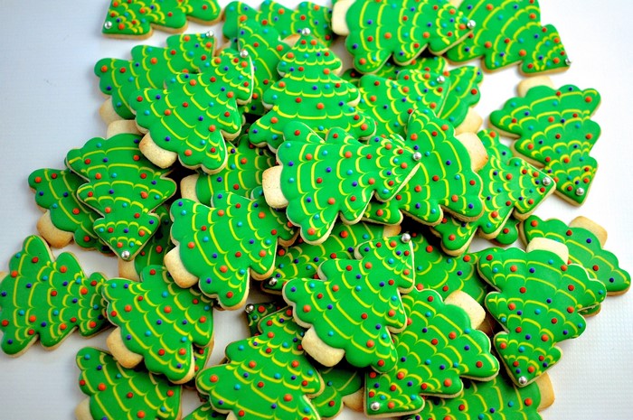 Christmas tree cookies with green icing and sprinkles