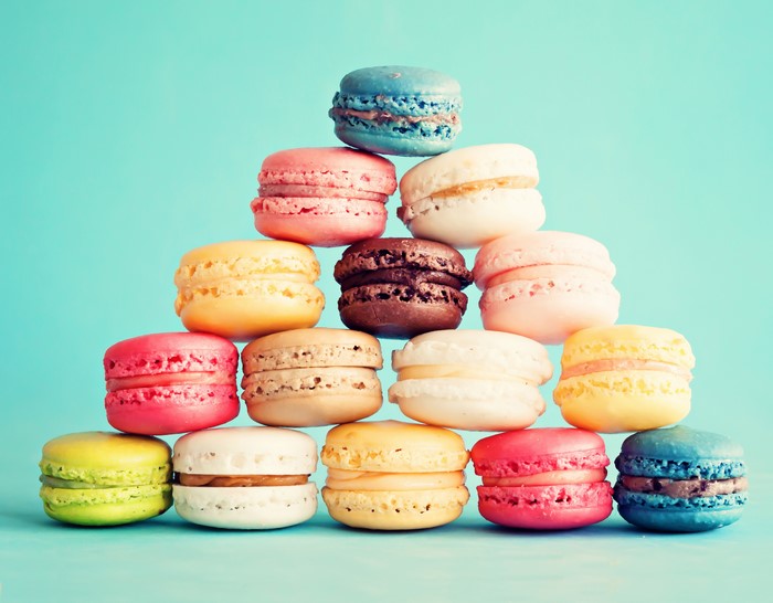 Pyramid of colorful macarons on blue background