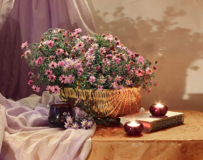 Still-life with asters, candles, book, cup, and basket