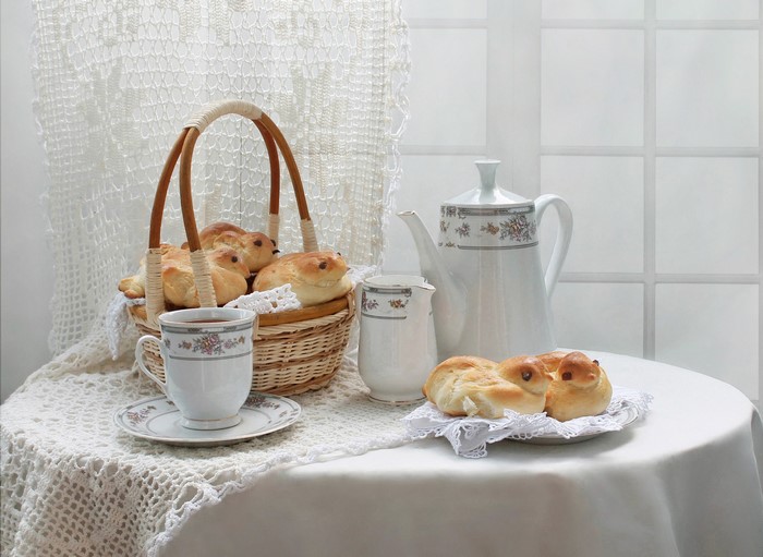 Still life with buns, tea, and a teapot