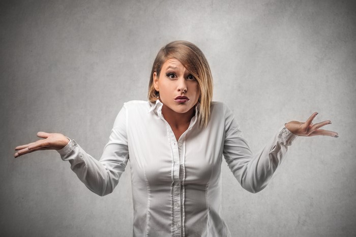 Blonde woman in formal shirt with surprise emotion