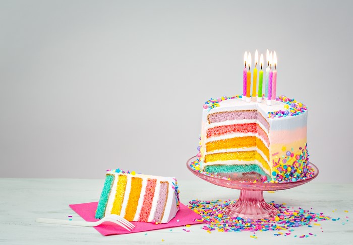 Rainbow Layer Cake with Candles and a Slice