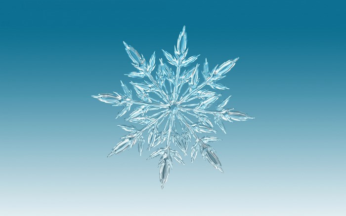 A detailed snowflake on a blue gradient background
