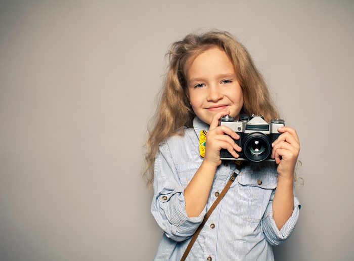 Girl holding a vintage camera