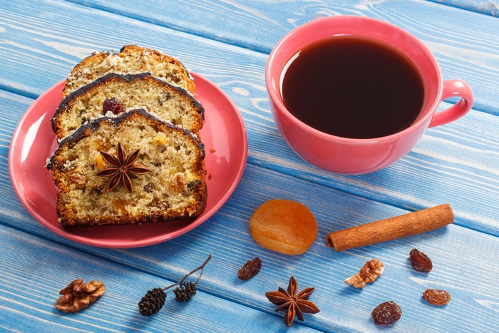 Slices of fruitcake with coffee and spices