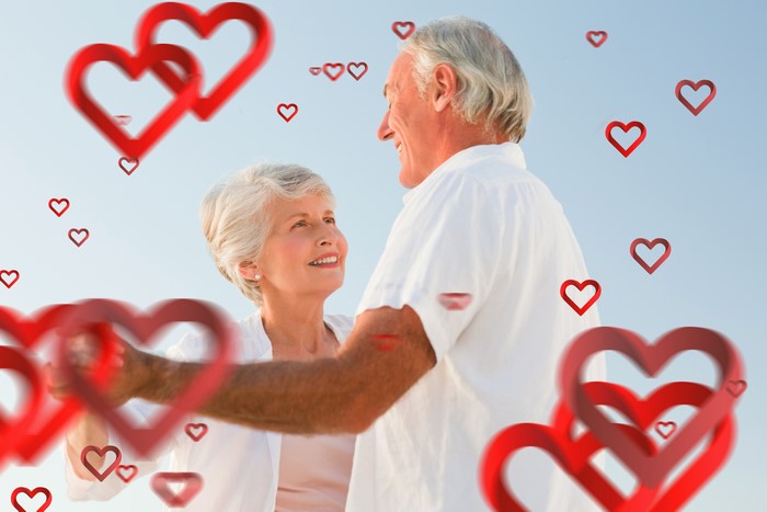 Elderly couple dancing with hearts