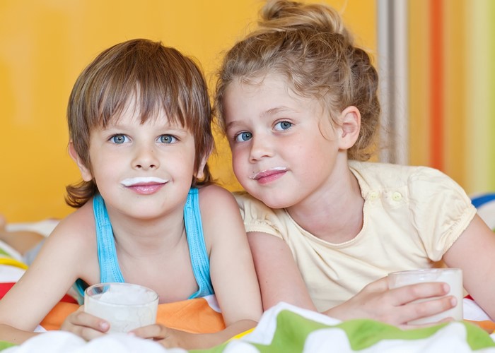 Two children with milk mustaches drinking milk