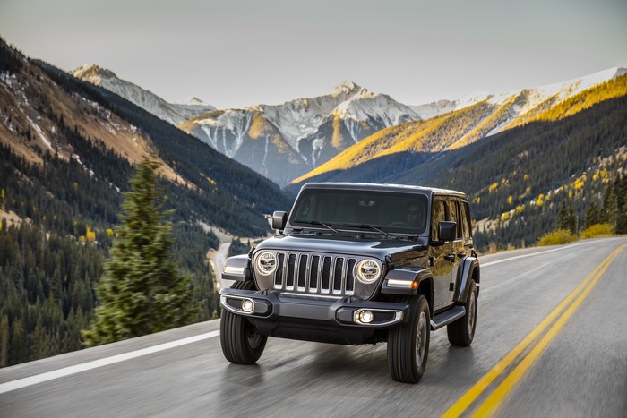 Black Jeep Wrangler driving on a mountain road