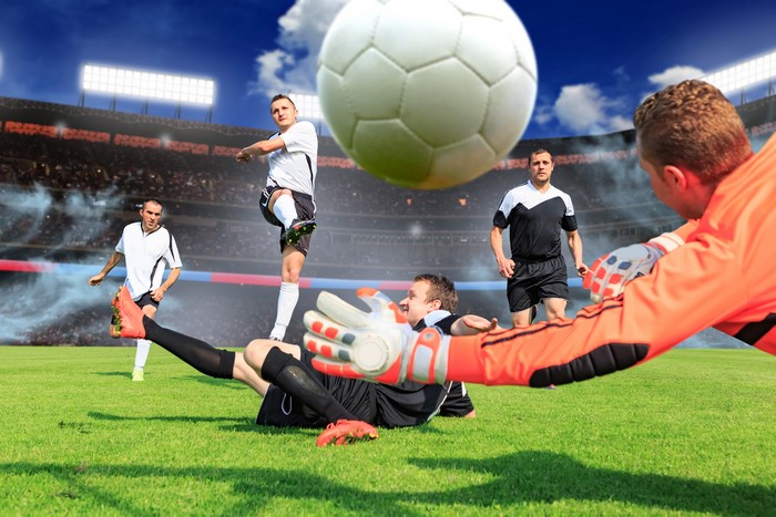 Soccer players in a stadium with a soccer ball