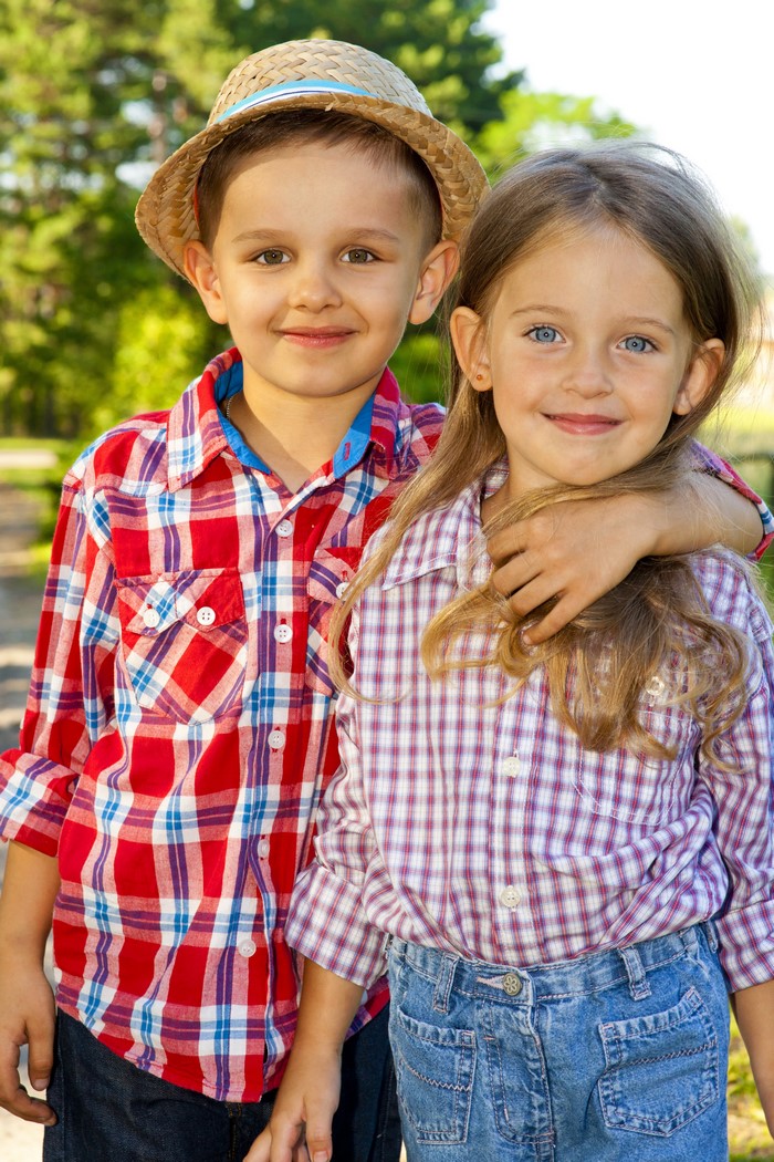 Boy and Girl in Plaid Shirts and Straw Hat