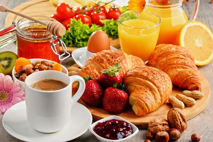 Breakfast with Croissants, Coffee, Juice, and Fruits