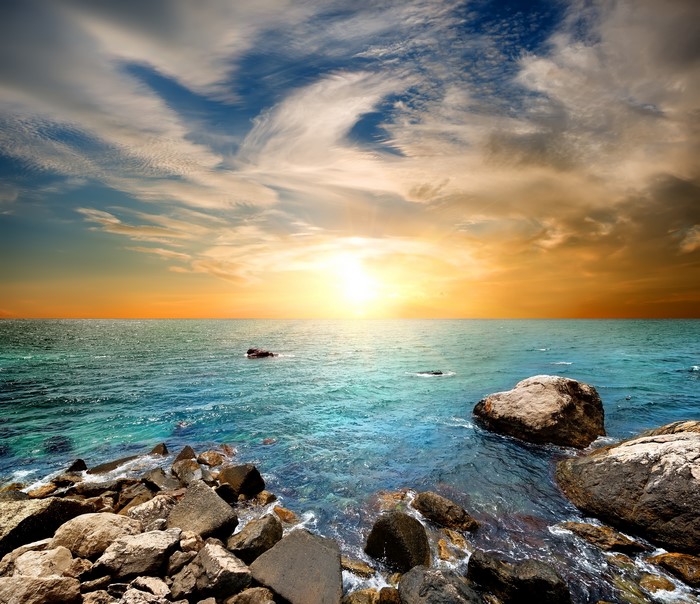 Sunset over the sea with rocks in Crimea