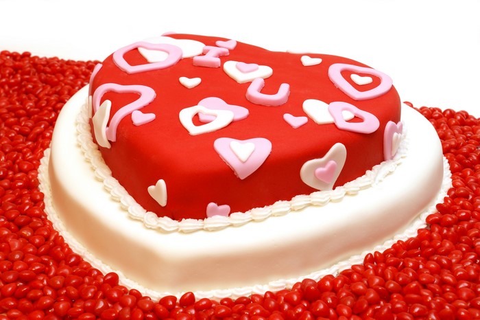 Heart-shaped cake decorated with hearts and candies