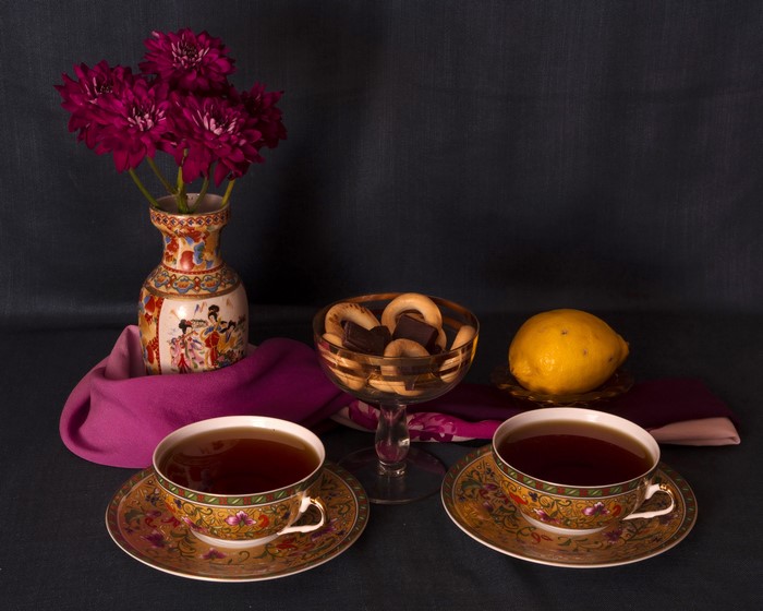 Still life with tea, pastries, and flowers