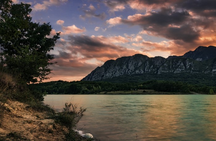 Lake Castel San Vincenzo with Mountains and Clouds in Italy
