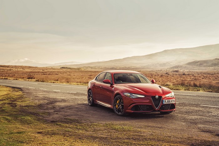 Red Alfa Romeo Giulia Quadrifoglio on a Road