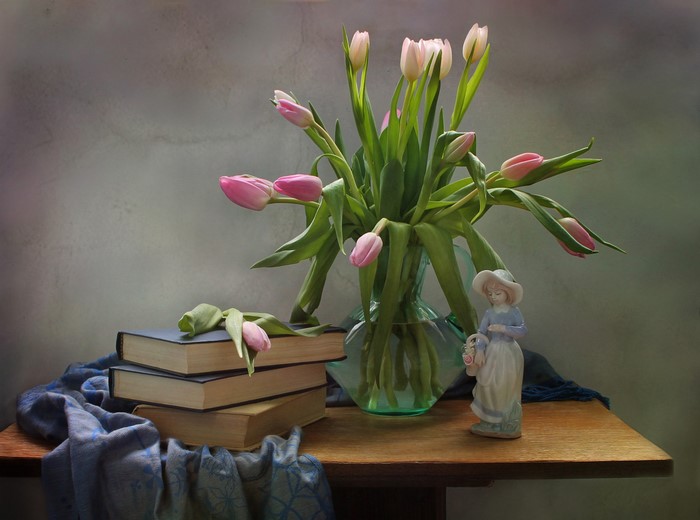 Still-life with pink tulips, books, and figurine