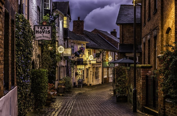 Cobblestone street with shops and lights in Stafford, England