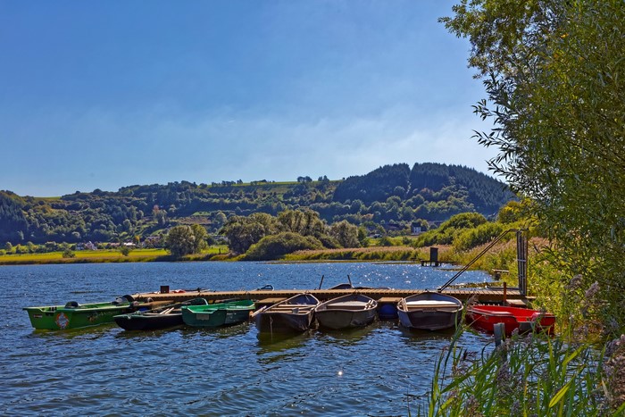Boats docked at a pier on a lake in Meerfelder, Germany