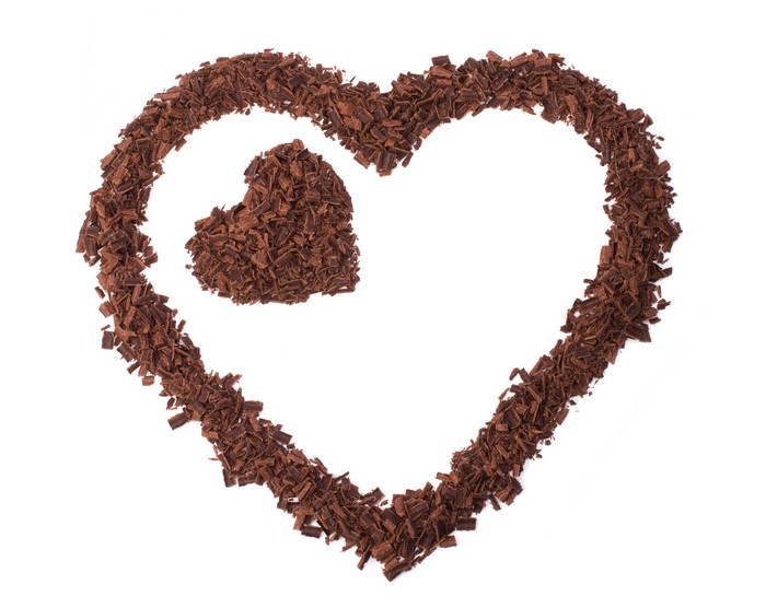 Chocolate shavings forming two hearts on a white background