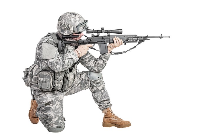 Soldier with assault rifle on white background