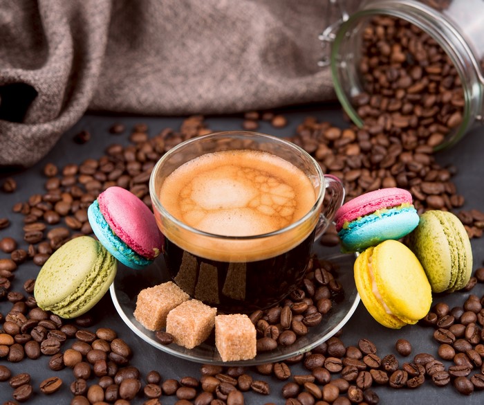 Espresso cup with macarons and coffee beans
