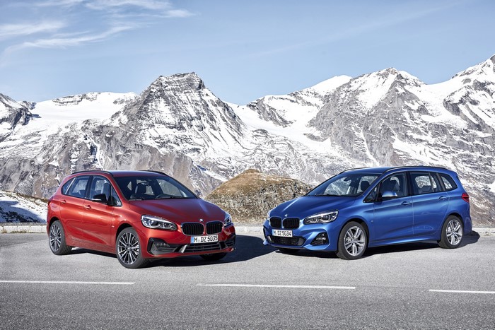 Two BMW 2 Series cars in mountains