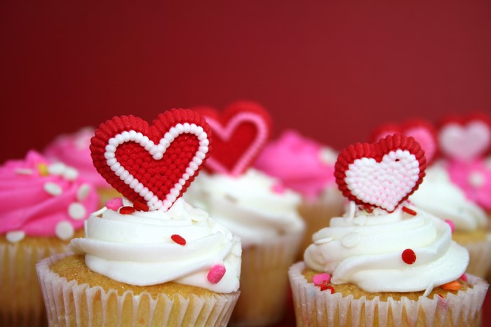 Cupcakes with Heart Decorations on Red Background