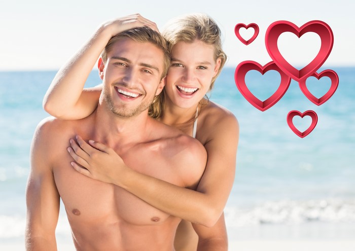 Couple Hugging on the Beach with Hearts