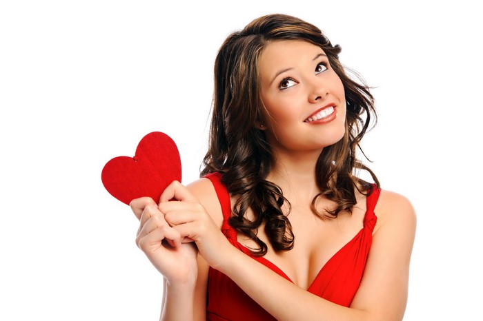 Woman in red dress holding a red heart
