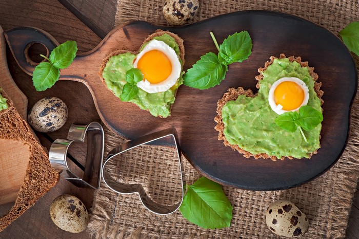 Heart-shaped avocado toast with quail eggs